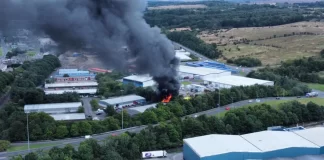 Firefighters fighting Cumbernauld industrial fire at Blairlinn Estate with smoke and flames, April 2025